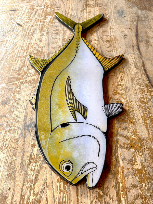 Decorative Jack Crevasse fish wall art on a wooden surface